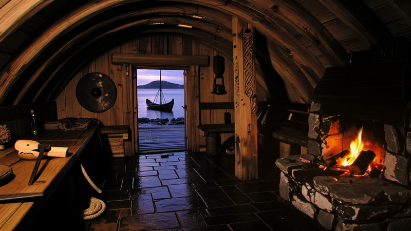 Tidekeeper’s Hall, a StillRoom film with a bright fire in a stone hearth and a view across the water